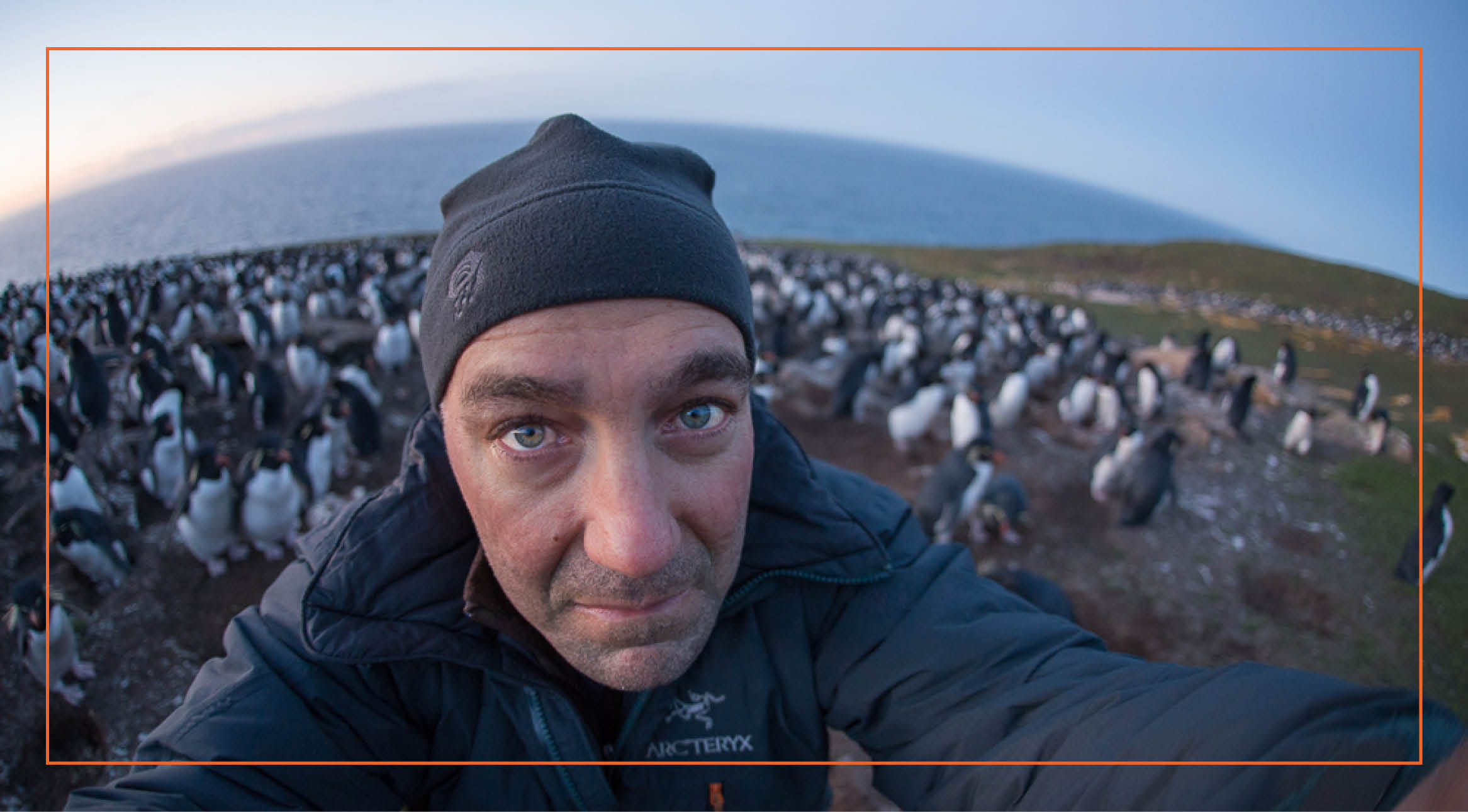 a selfie by Sean Crane surrounded by penguins