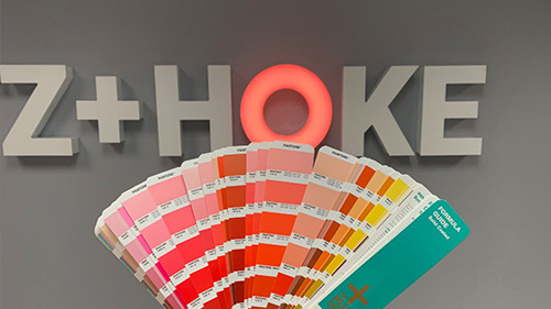 color swatches being held up in front of mintz + hoke sign